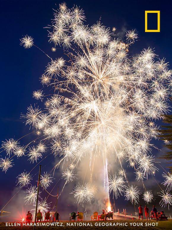Sparks fly in this red, white, and blue moment captured by Your Shot photographer Ellen Harasimowicz during a backyard 4th of July celebration. "Watching the fireworks explode in the sky and fall into the water just a few feet away is breathtaking," she writes. https://on.natgeo.com/2XjkcP6